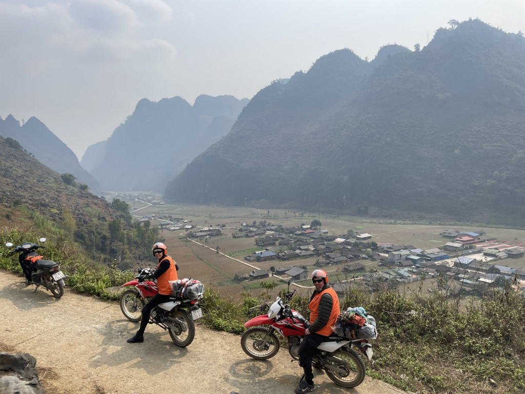 Ha Long Bay mountain view with motorbikes and travelers enjoying the scenic ride.