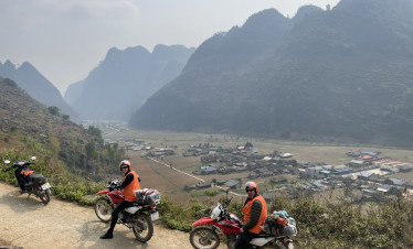 Ha Long Bay mountain view with motorbikes and travelers enjoying the scenic ride.