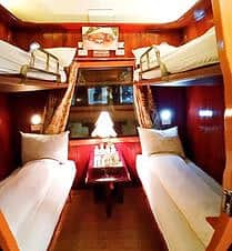 Luxury cruise cabin with cozy beds and elegant decor in Halong Bay.