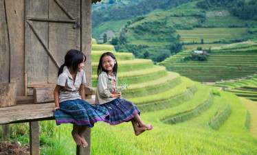 Rice terraces and children enjoying the view in Vietnam.