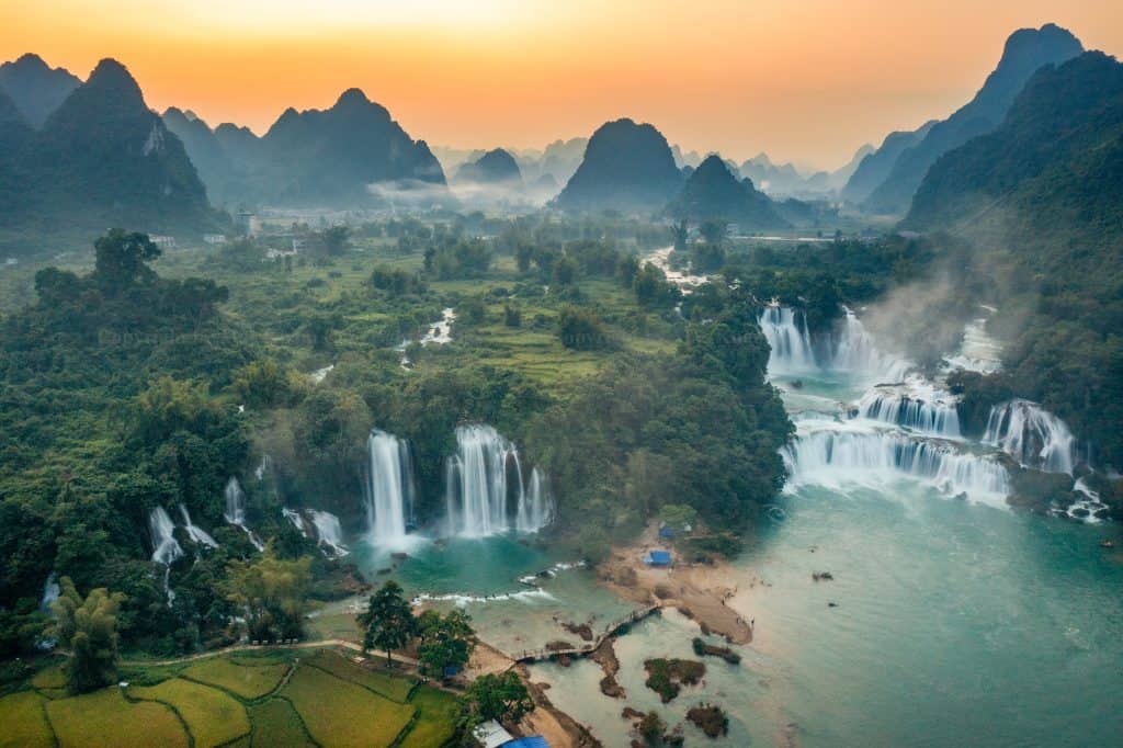 Halong Bay sunset landscape with limestone karsts and calm waters, perfect for a memorable cruise ex.