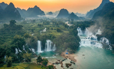 Halong Bay sunset landscape with limestone karsts and calm waters, perfect for a memorable cruise ex.