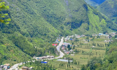Ha Giang valley mountain landscape with lush greenery and small village.