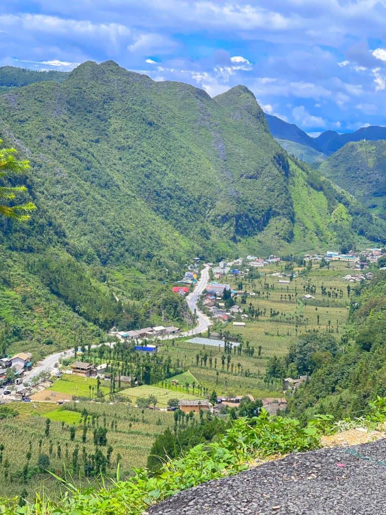 Ha Giang valley mountain landscape with lush greenery and small village.