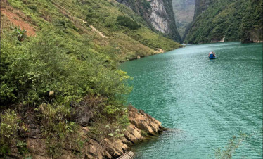 Ha Long Bay scenic view with emerald waters and towering limestone cliffs.