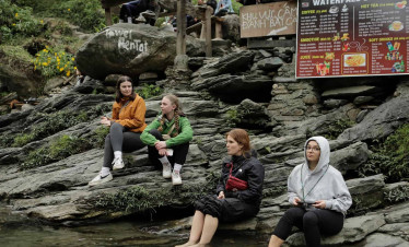 Hanoi waterfall scene with friends enjoying coffee and nature, perfect for a peaceful retreat.