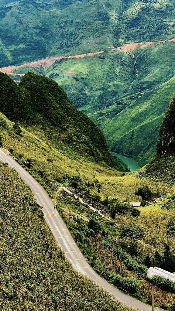 Ha Giang mountain pass winding through lush green valleys.