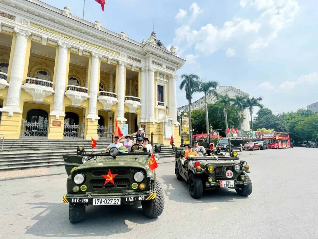 Hanoi city sightseeing in vintage jeeps with vibrant street views and historic architecture.