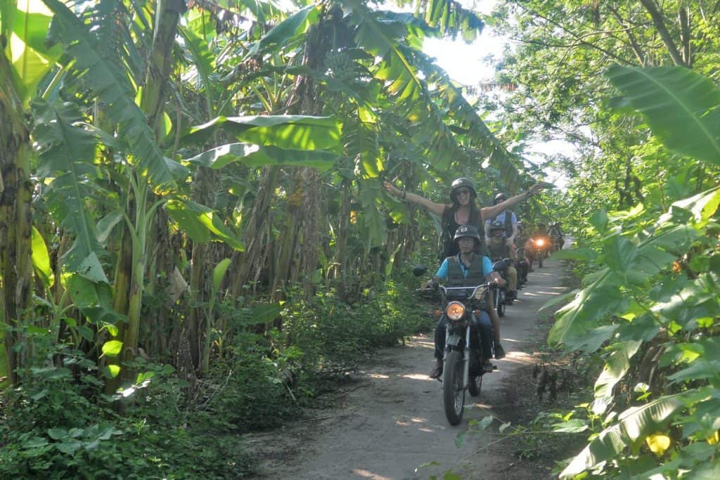 Motorbike tour through lush green jungle in Hanoi.