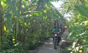 Motorbike tour through lush green jungle in Hanoi.