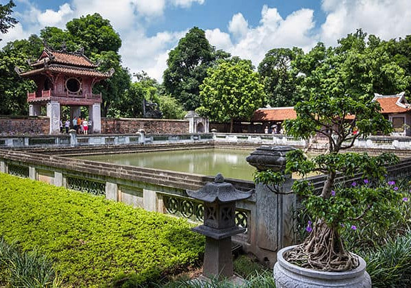 Hanoi city garden with traditional architecture and lush greenery.
