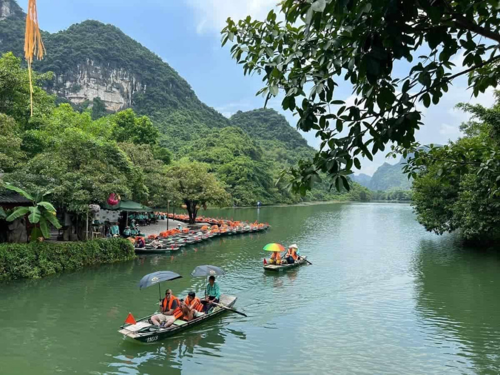 Halong Bay boat tour exploring stunning limestone karsts and emerald waters.