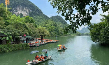 Halong Bay boat tour exploring stunning limestone karsts and emerald waters.