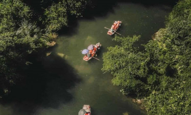 Halong Bay boat tour exploring stunning limestone karsts and emerald waters.