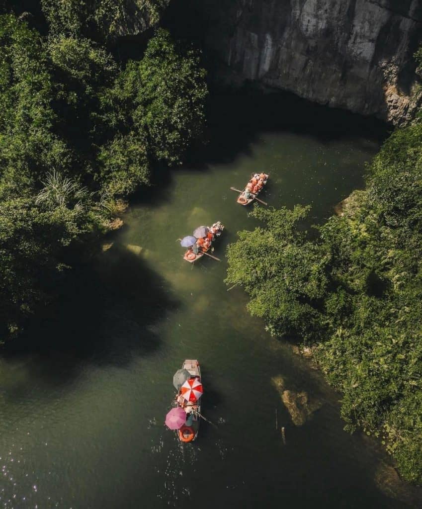 Halong Bay boat tour exploring stunning limestone karsts and emerald waters.