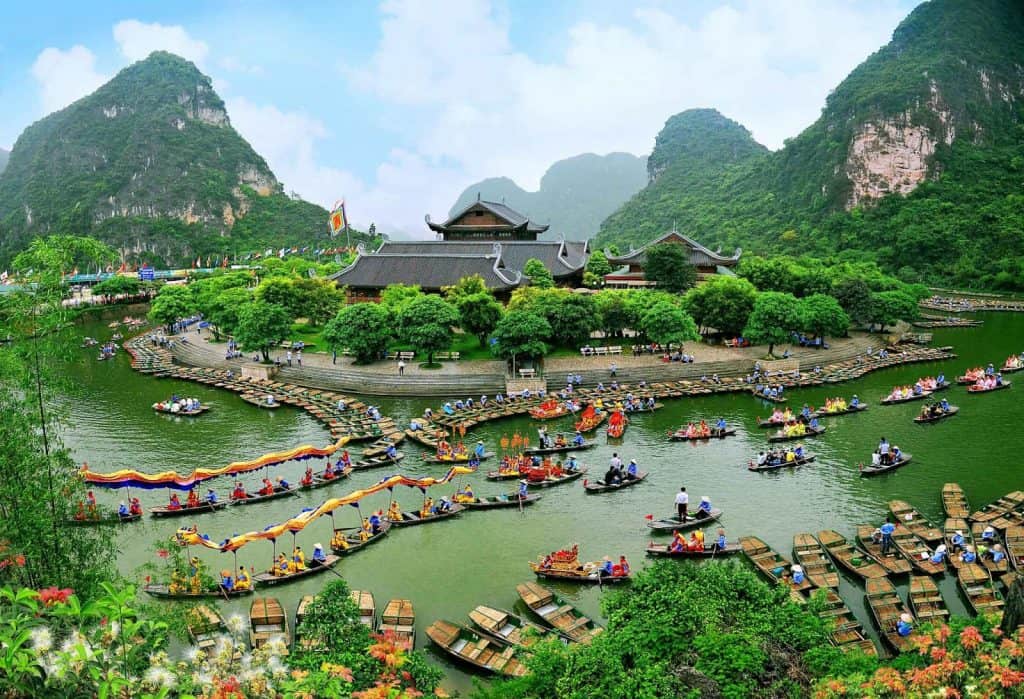 Halong Bay boat tour with stunning limestone karsts and emerald waters.