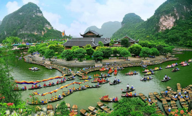 Halong Bay boat tour with stunning limestone karsts and emerald waters.