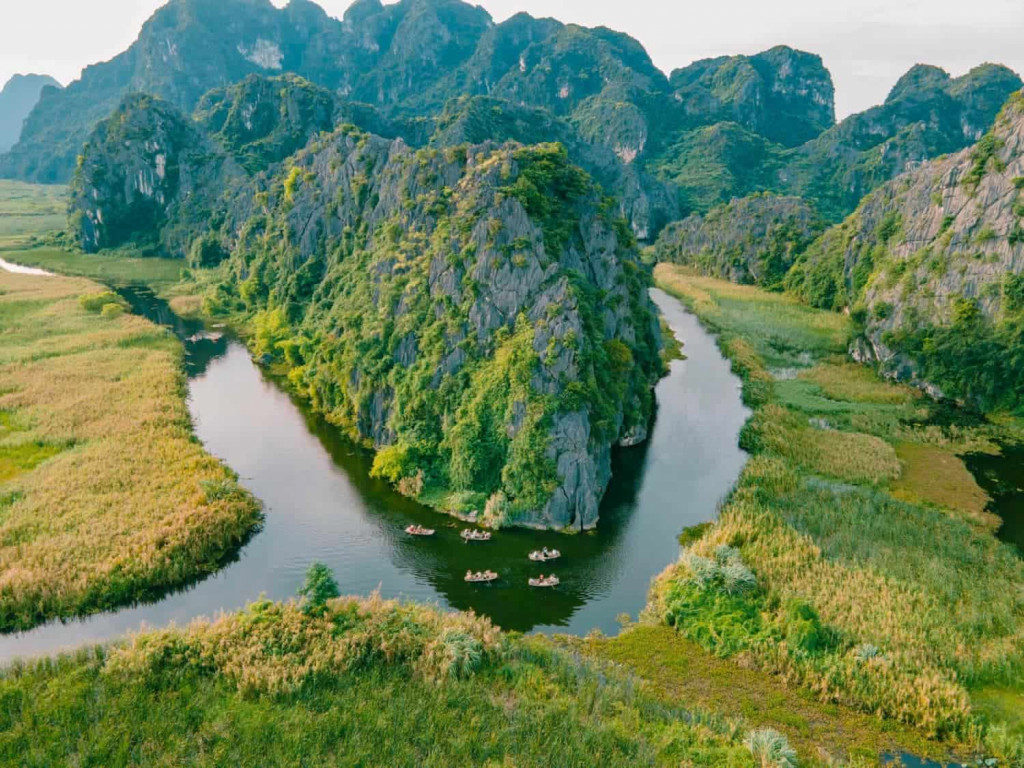 Halong Bay scenic landscape with towering limestone karsts and lush greenery.