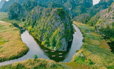 Halong Bay scenic landscape with towering limestone karsts and lush greenery.