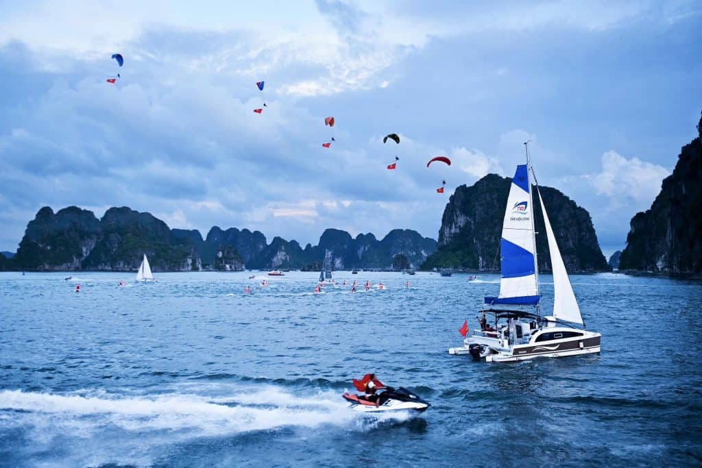 Yachting adventure in Halong Bay with stunning limestone karsts and clear waters.