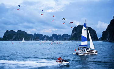 Yachting adventure in Halong Bay with stunning limestone karsts and clear waters.