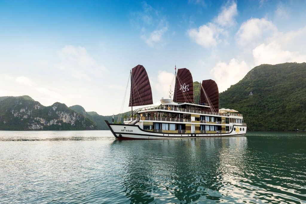 Luxury cruise sailing through Halong Bay's stunning limestone karsts.