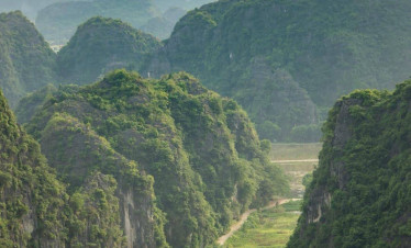 Halong Bay scenic view with lush green islands and calm waters.