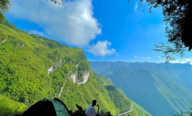 Hiking in Sapa with stunning mountain views and lush greenery.