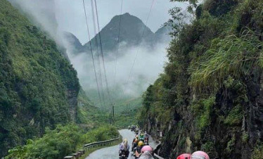 Ha Giang mountain road adventure in rainy weather.