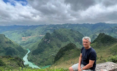 Ha Giang mountain landscape with a traveler enjoying the view.