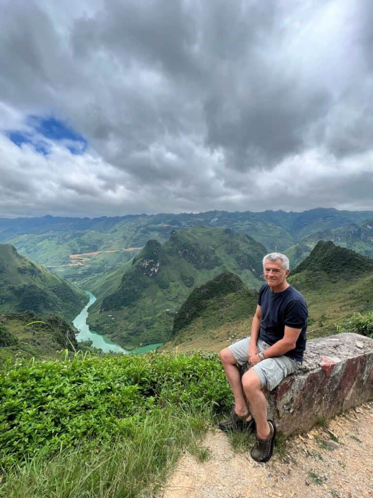 Ha Giang mountain landscape with a traveler enjoying the view.