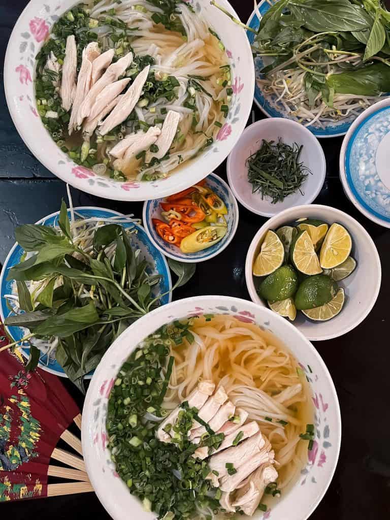 Vietnamese noodle soup with fresh herbs and lime.