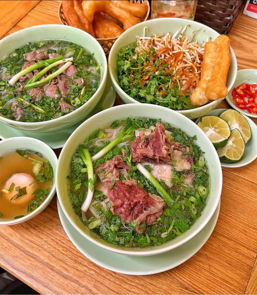 Vietnamese Pho Soup with Fresh Herbs and Beef.