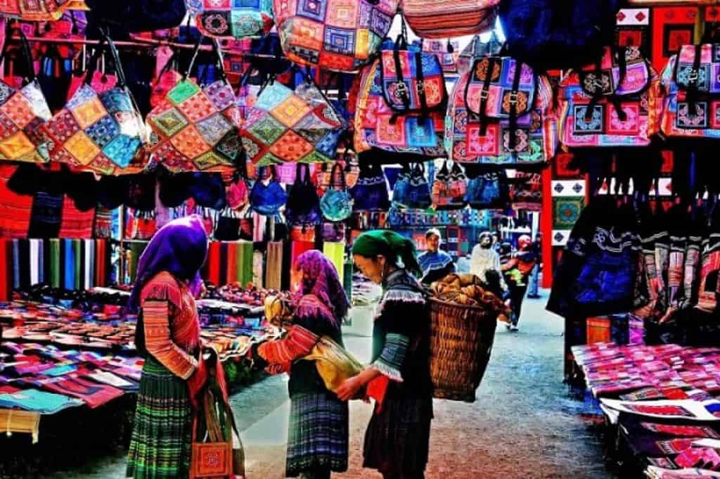 Vibrant local market scene showcasing colorful textiles and traditional crafts in Sapa.