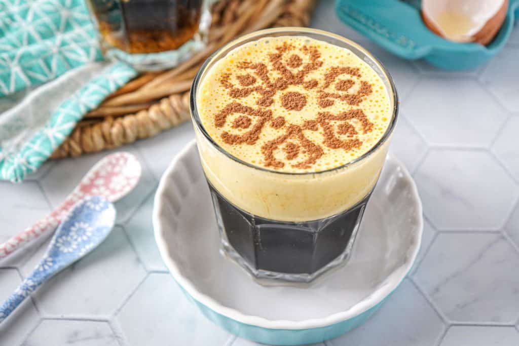 Vietnam coffee topped with intricate cocoa powder design.