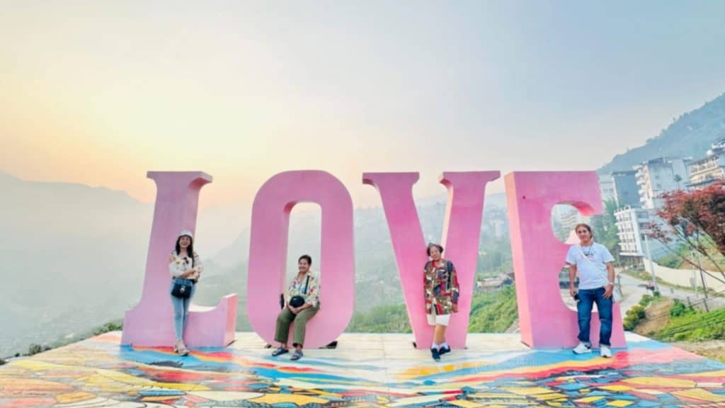 Love Sapa scenic viewpoint with visitors enjoying the breathtaking mountain scenery.