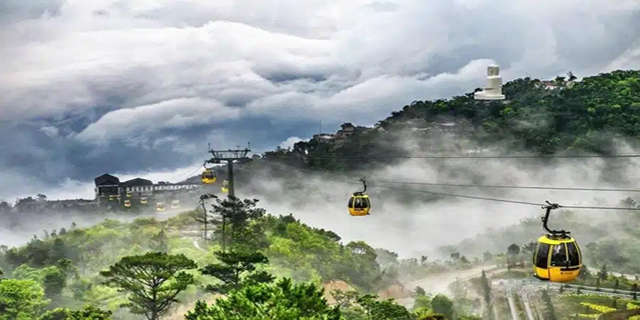 Sapa cable cars glide over lush green mountains, offering breathtaking views and a serene travel exp.