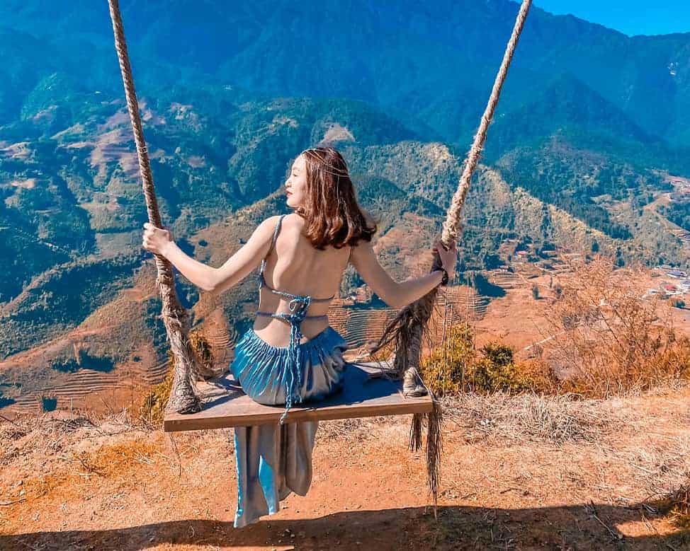 Sitting on a scenic mountain swing in Sapa, enjoy breathtaking views and a peaceful escape into natu.