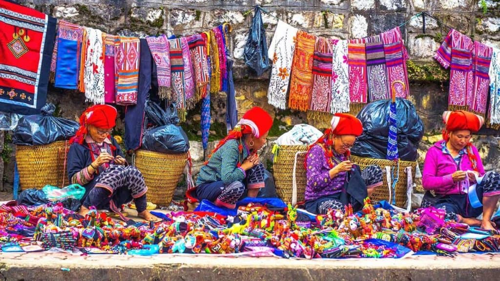Colorful market scene showcasing traditional textiles and crafts in Sapa, Vietnam.
