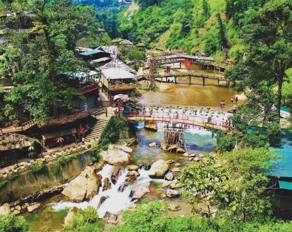 Scenic waterfall in Sapa surrounded by lush greenery, perfect for nature lovers.