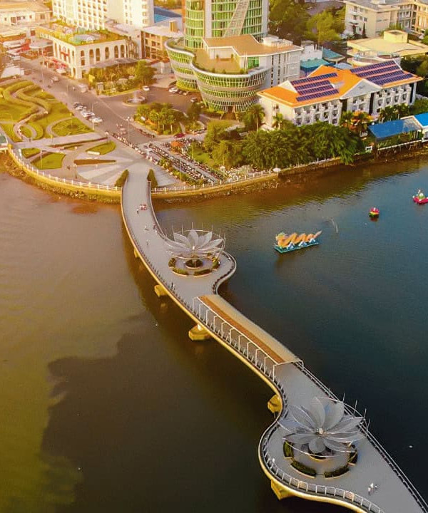 Mekong River and cityscape with boats and modern buildings, showcasing Vietnam’s vibrant delta life.