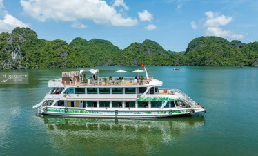 Serenity Cruise floating on tranquil Lan Ha Bay surrounded by lush green islands, offering a luxurio.