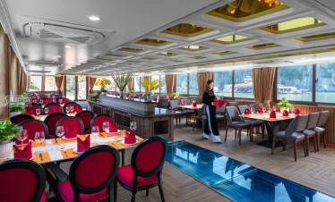Luxury cruise dining area with elegant decor and panoramic bay views.