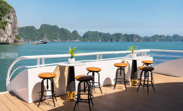 Serenity Cruise lounge with scenic Lan Ha Bay views, perfect for relaxing and enjoying the stunning.