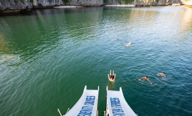Lan Ha Bay scenic water view with swimmers enjoying the cruise experience.