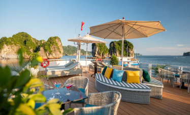 Lan Ha Bay luxury cruise deck with seating and umbrellas.