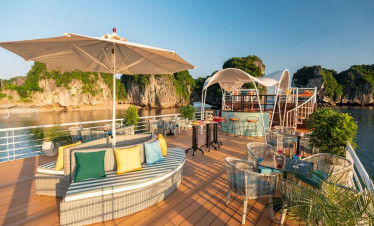 Lan Ha Bay luxury cruise deck with seating and sunshade.