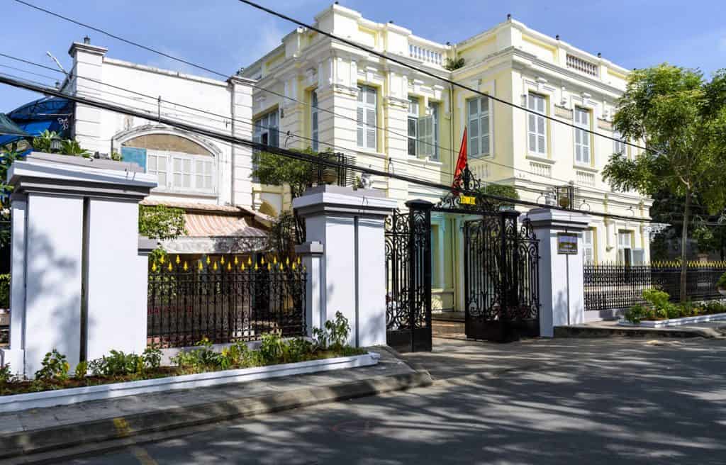 Elegant colonial-style villa with lush greenery and classic architecture.