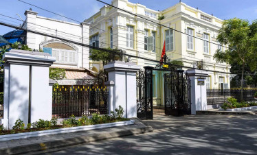 Elegant colonial-style villa with lush greenery and classic architecture.