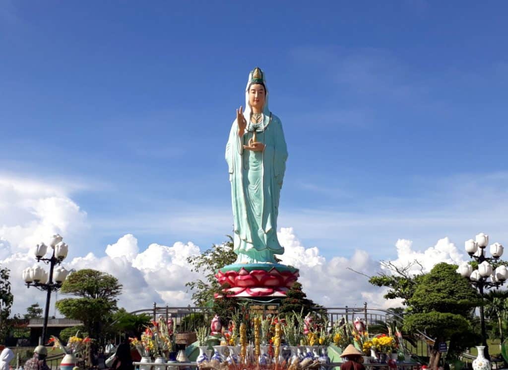Linh Ung Pagoda's majestic Buddha statue offers a serene spiritual experience amidst lush greenery.